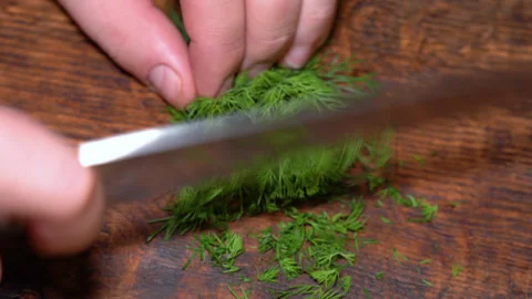 Close-up of cut parsley on a board in the kitchen with a knife. Stock Footage 255601498