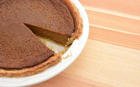 Close-up of cut pumpkin pie with slice taken Stock Photos