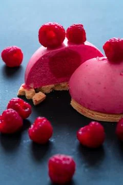 Close Up Of Cut Raspberry Mousse Tartlet With Strawberry Yogurt Filling Decor Stock Photos