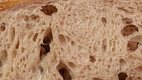 Close up of a cut of sourdough bread. Zoom out. Stock Footage 308920553