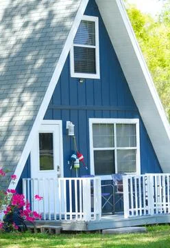 Close up of cute adorable A frame triangle shaped house or home with deep b.. Stock Photos