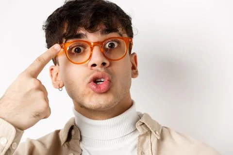 Close-up of cute and funny guy in glasses pointing at eyewear frames Stock Photos