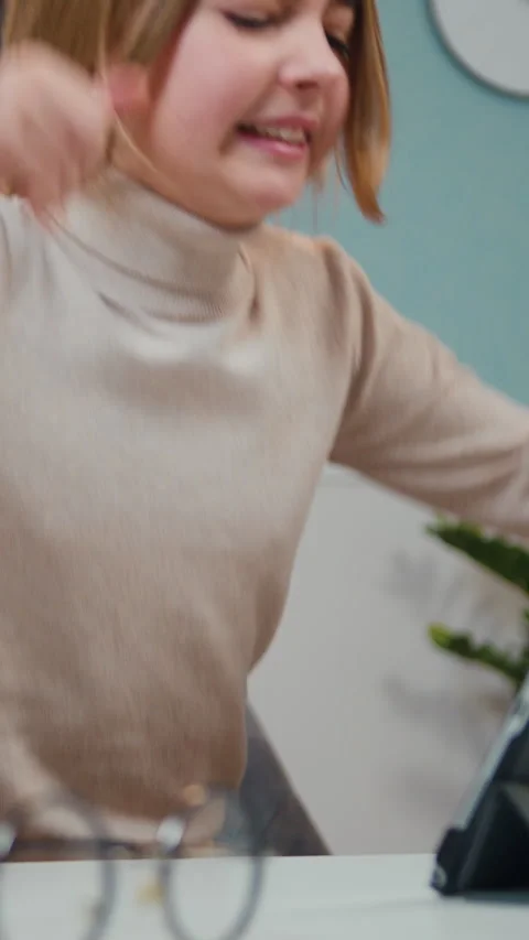 Close up of cute and hapy little girl uses tablet device while sitting at the de Stock Footage 330194535