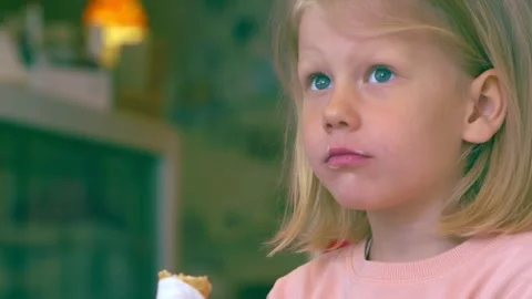 Close up of cute and smiling blonde little girl holding ice cream Видео 169246228
