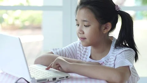Close up of cute Asian girl using laptop  slow motion Stock Footage 79208367