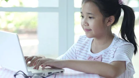 Close up of cute Asian girl using laptop Stock Footage 79253114