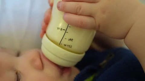 Close-up of a cute baby drinking his milk bottle. Stock Footage 301367699