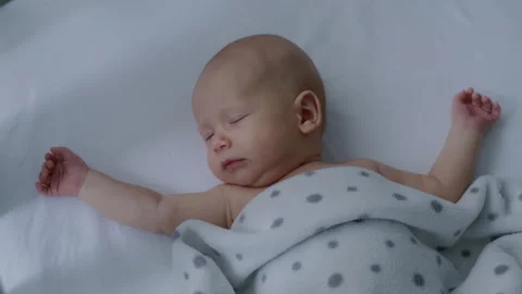 Close up, cute, beautiful, innocent newborn baby falling asleep in bed Stock Footage 306044193
