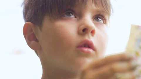 Close up of a cute boy learning and asking questions in slow motion Stock Footage 80012643