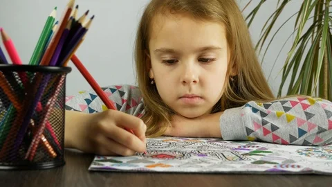 Close up cute child coloring in anti stress book Stock Footage 86532792