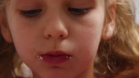 Close-up of a cute, cute child girl chewing on a sushi roll Stock Footage 196123764