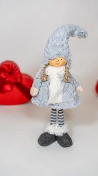 Close up of cute doll with gift boxes in form of heart on isolated white back Stock Photos
