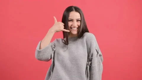 Close up of a cute girl doing talking on the telephone gesture. Stock Footage 141187478