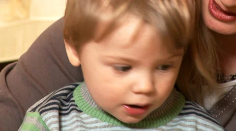 Close up of a cute little boy learning and exploring books with fascination. Stock Footage 32961694