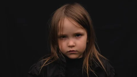 Close-up of a cute little strong athletic girl in black clothes angry Stock Footage 104998035