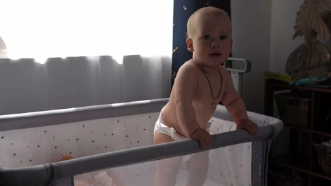Close-up Cute Nake diaper Kid 10 Month Newborn Boy Looking At Camera crawling Vídeos de archivo 197636413