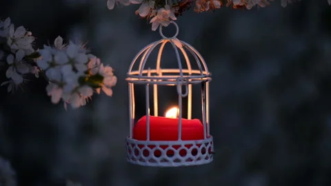 Close up of a cute red candle in white candle lantern Stock Footage 99754932