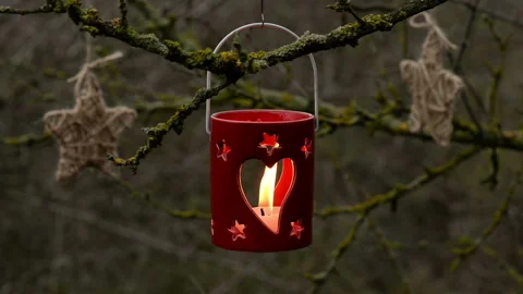 Close up of a cute red ceramic candle lantern vs white candle Stock Footage 139776025
