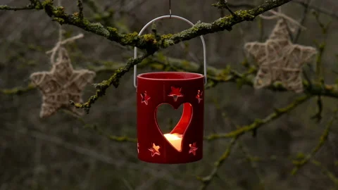 Close up of a cute red ceramic candle lantern vs white candle Stock Footage 139776142