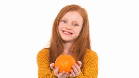 Close-up of a cute red haired young model posing at camera. Charming girl is Stock Footage 121796887