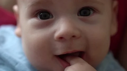 Close-up Cute Smiling Face Of Newborn Baby In Early Days Wakes Up Sticks Finger Stock-Footage 169716081
