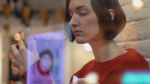 Close up of cute young woman using smartphone taking selfie sitting in cafe. Stock Footage 83082567