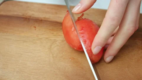 Close-up of cutting and chopping tomatoes for a salsa on a cutting board in 4K. Stock Footage 142672967