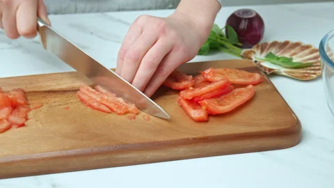 Close-up of cutting and chopping tomatoes for a salsa on a cutting board in 4K. Stock Footage 142673446