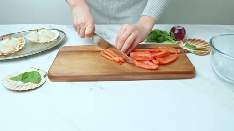 Close-up of cutting and chopping tomatoes for a salsa on a cutting board in 4K. Stock Footage 142673506