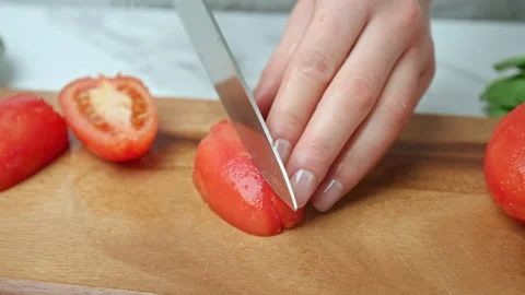 Close-up of cutting and chopping tomatoes for a salsa on a cutting board in 4K. Stock Footage 142710000