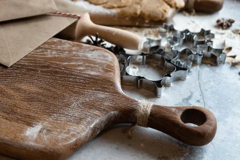 Close up of cutting board and cookie cutters. Stock Photos