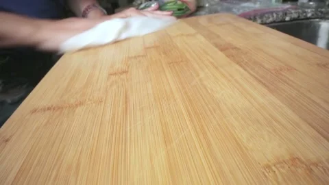 Close-up of cutting board being cleaned by female hands Stock Footage 132212107