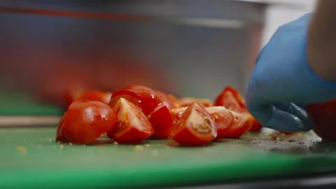 A close up of a cutting board with a pile of sliced tomatoes Stock Footage 297843981