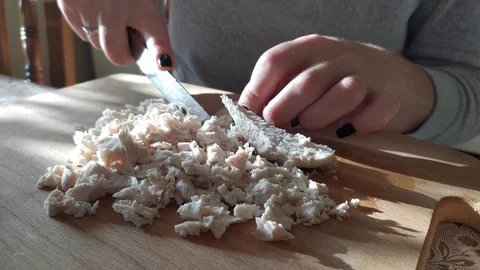 Close-up. cutting boiled meat into small pieces. cooking salad in the kitchen. Stock Footage 121002903