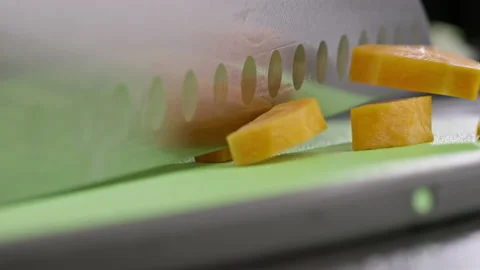 Close-up of cutting carrot rings into two parts with a knife Vídeo Stock 224959027