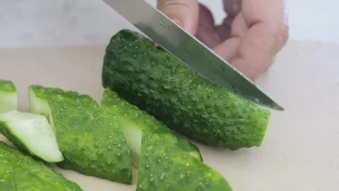 Close-up of cutting cucumbers with knife. Stock Footage 286434108