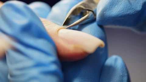 Close-up of cutting cuticles with manicure nippers. Stock Footage 314462664