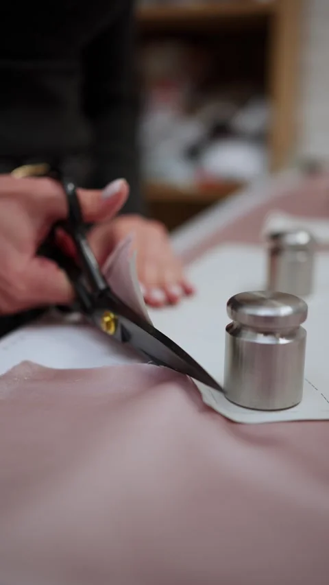 Close-up of cutting fabric with scissors. Concept of cutting fabric. Stock Footage 296650781