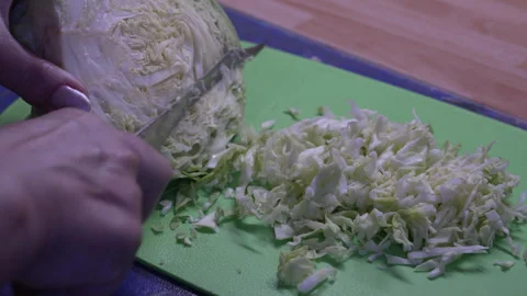 Close-up of cutting fresh green cabbage on a board, 8K Vídeos de archivo 335234847
