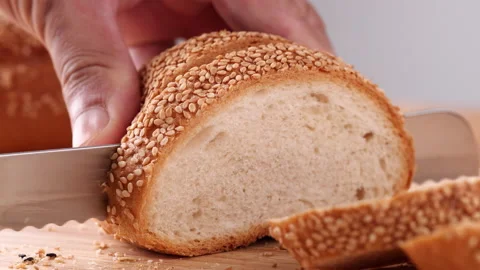 Close up cutting fresh hamburger bun, bread rolls with sesame seeds Stock Footage 165345462