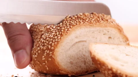 Close up cutting fresh hamburger bun, bread rolls with sesame seeds Stock Footage 165347670