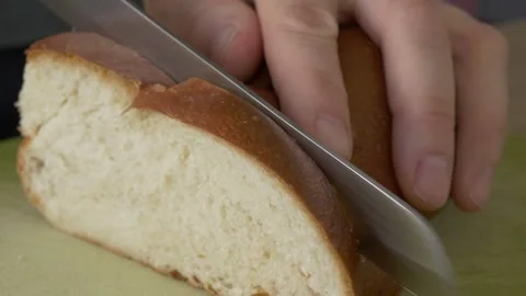 Close-up cutting a loaf of very soft white bread 库存影片 290050836