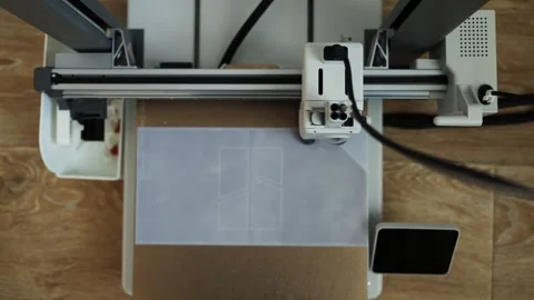 Close-up of a cutting machine precisely scoring paper on a wooden desk Stock Footage 339185783