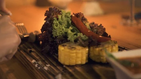 Close up cutting meat steak while dinner in evening restaurant. Woman eating Stock Footage 103648028