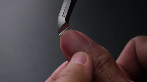 Close-up of cutting nails. Hands are cutting nails using nail clippers. Stock Footage 248504046