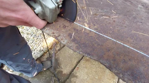 Close-up of Cutting Old Rusty Metal Plate with Angle Grinder and Flying Sparks Stock Footage 333642343