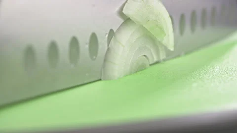 A close-up of cutting an onion with a knife on a board. Stock Footage 228305940