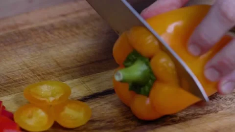Close Up Cutting of Orange Pepper Stock Footage 166863099
