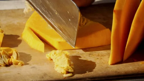 Close up of Cutting orange pumpkin into cubes Stock Footage 138543369
