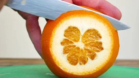 Close Up Of Cutting Orange Into Slices On A Cutting Board Stock Footage 133137832